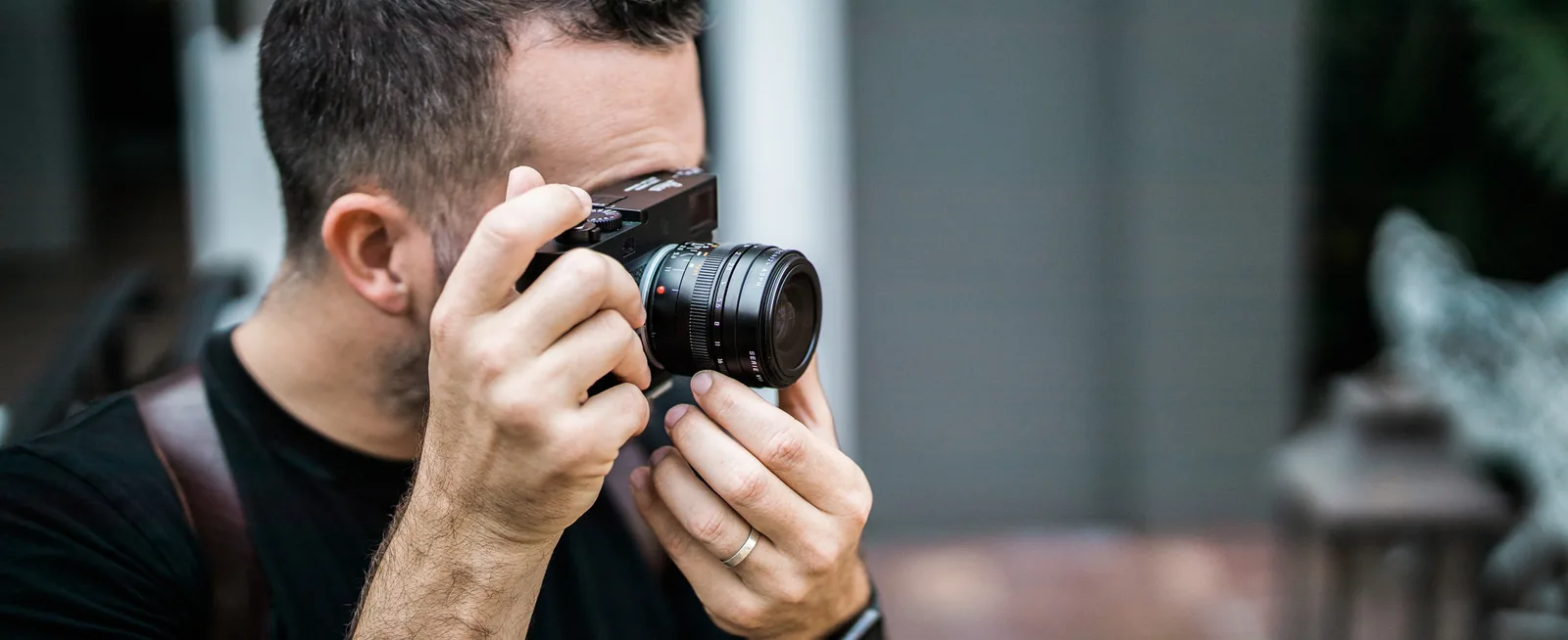 Bud Johnson raising a rangefinder camera to his eye
