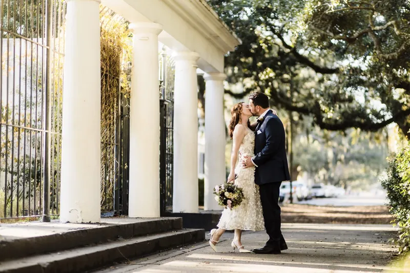 Couple between white columns under the oaks