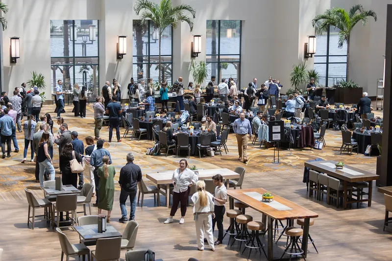 Conference attendees networking in a bright atrium